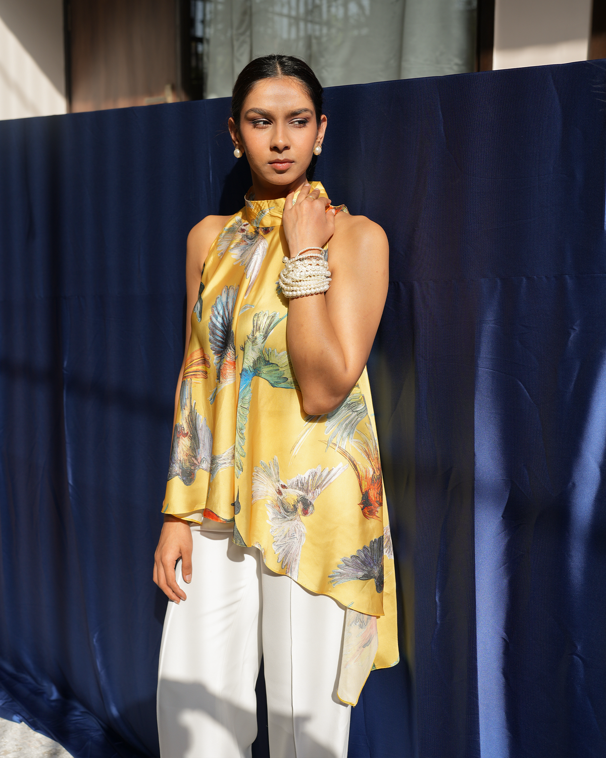 Jiya by House of Somarra — Front portrait of the yellow halter top and scarf-like neckline.