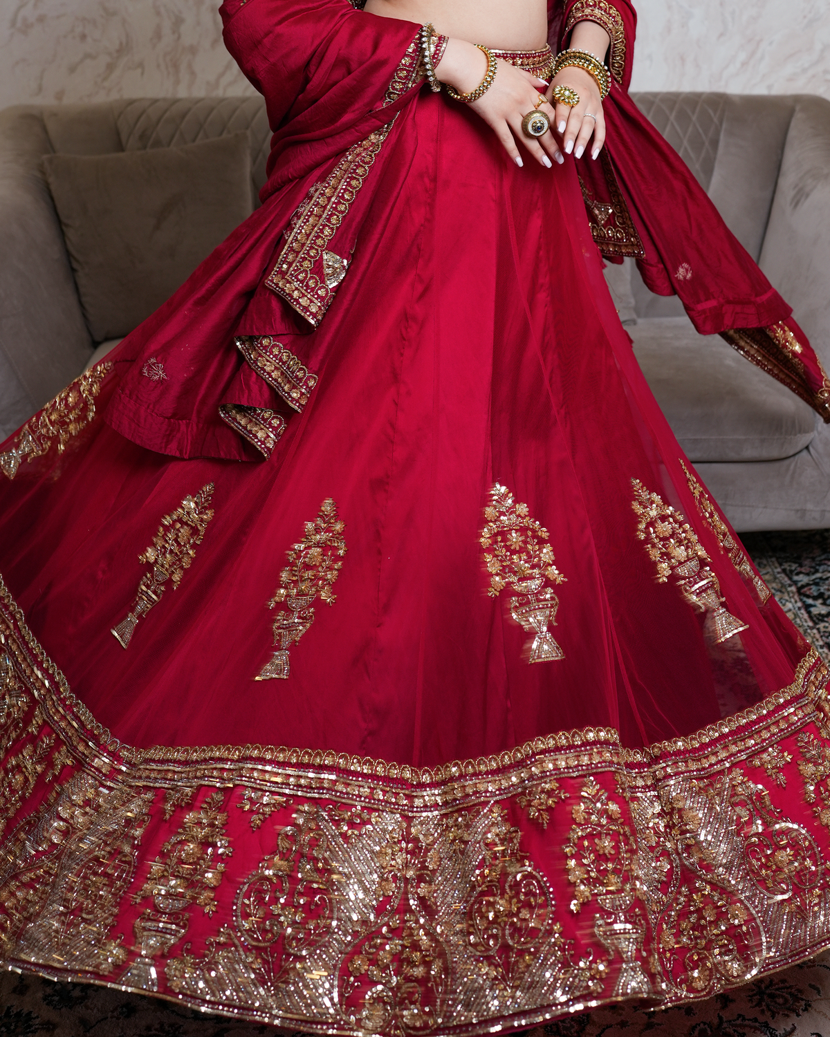 Afsana by House of Somarra — Seated detail of the crimson skirt and ornate embroidered hem.