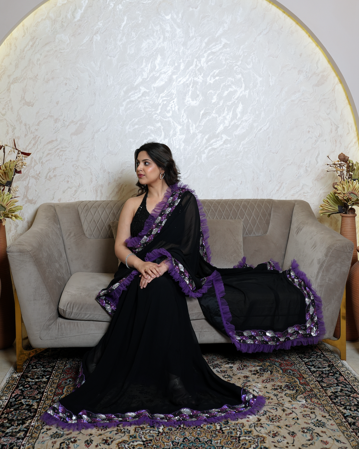 Zaria by House of Somarra — Seated side view showing the ruffled pallu.