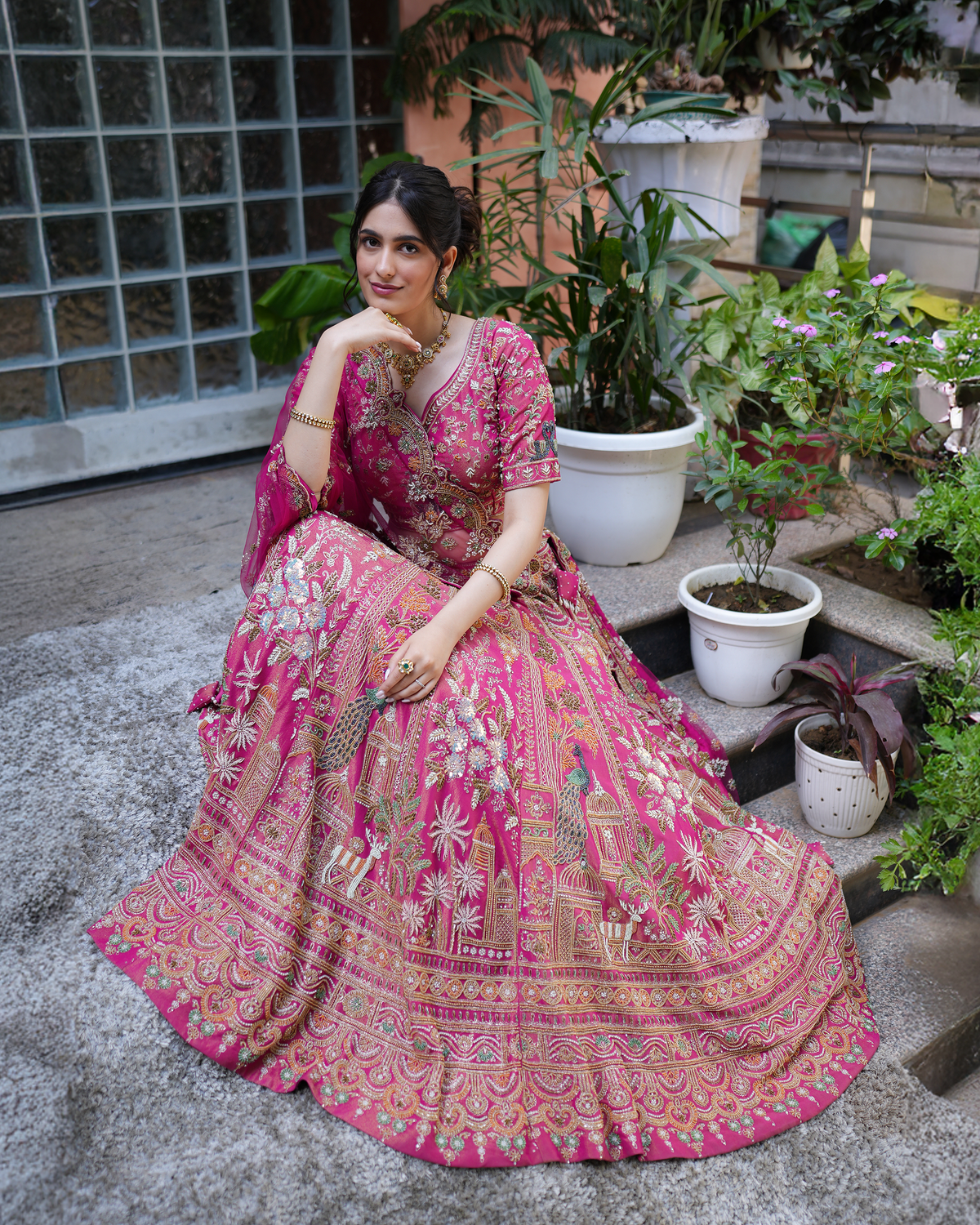 Aakriti by House of Somarra — Seated three-quarter view of the embroidered blouse and lehenga.