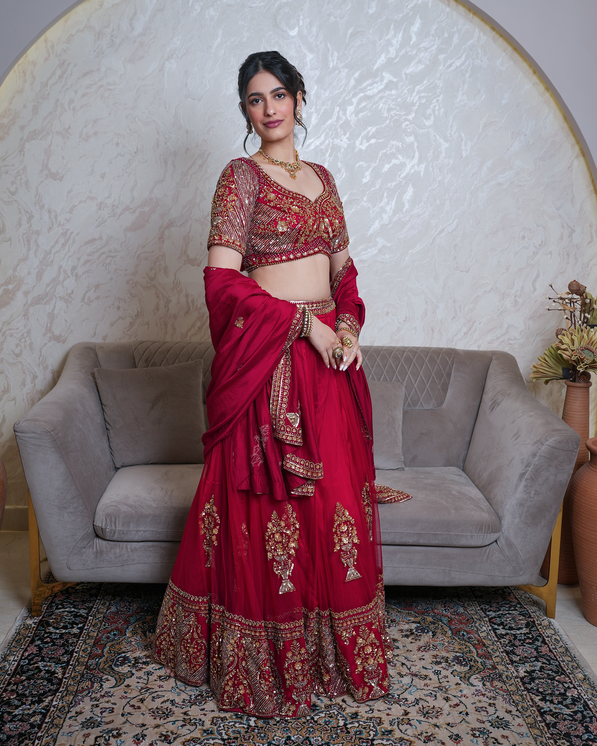 Afsana by House of Somarra — Full-length front view of the crimson lehenga and gold-toned embroidery.