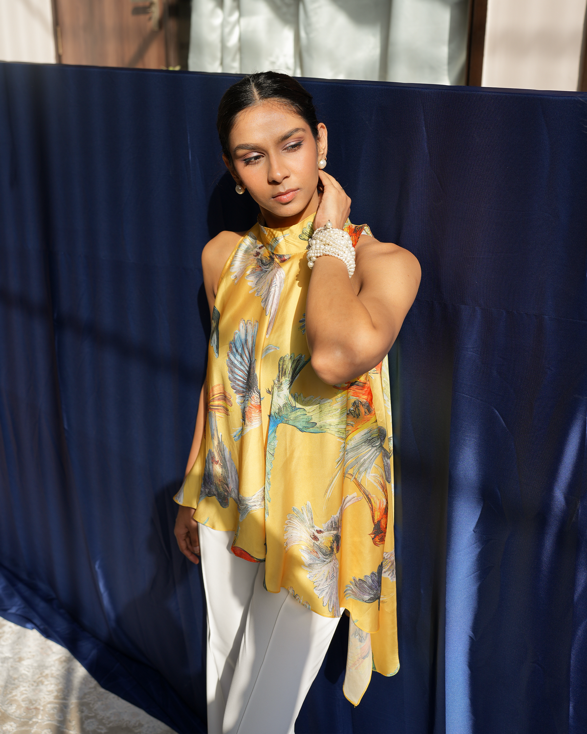 Jiya by House of Somarra — Side portrait showing the halter neckline and printed fabric.