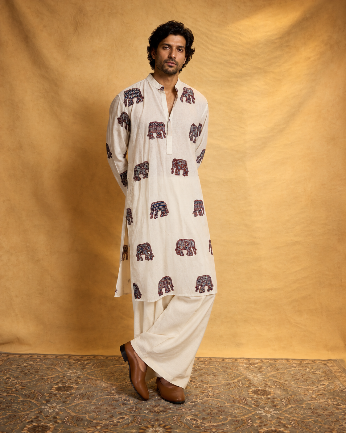 Hasti by House of Somarra — Full-length view of the ivory elephant-print kurta and ivory trousers.