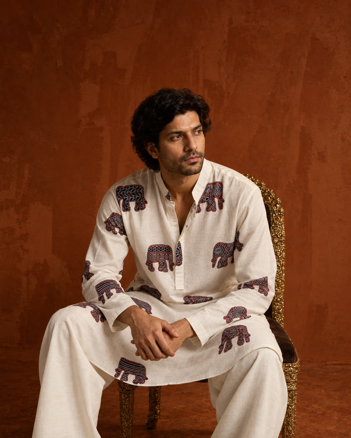 Hasti by House of Somarra — Seated view showing the printed kurta and plain ivory trousers.