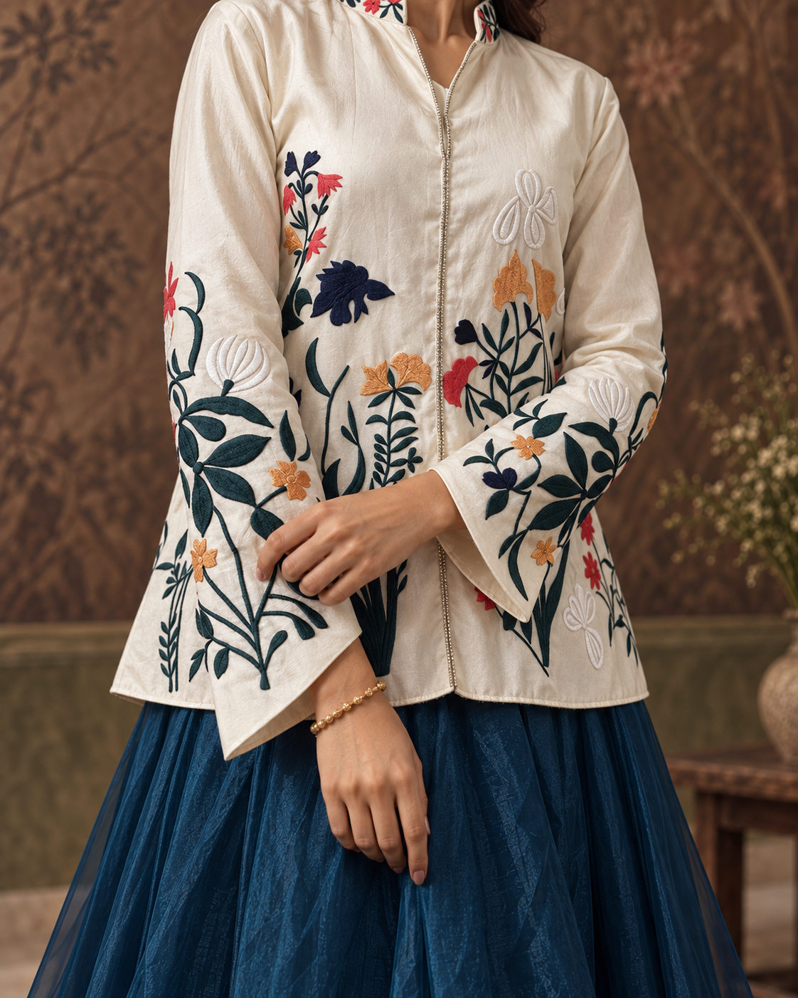 Samaira by House of Somarra — Close-up of the floral embroidery and pointed cream hem.