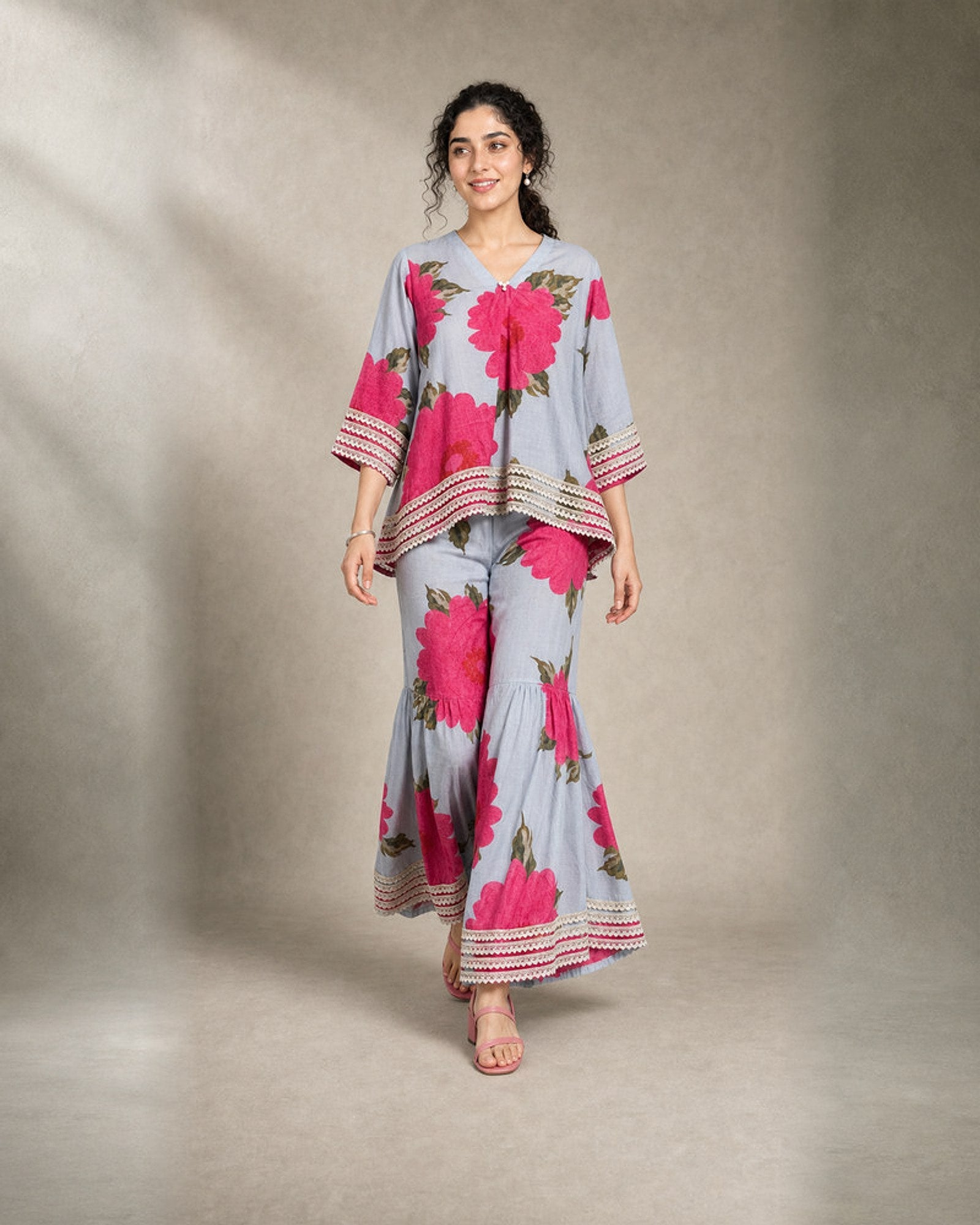 Gulaira bold pink floral lace garara co-ord set – controlled front walking view