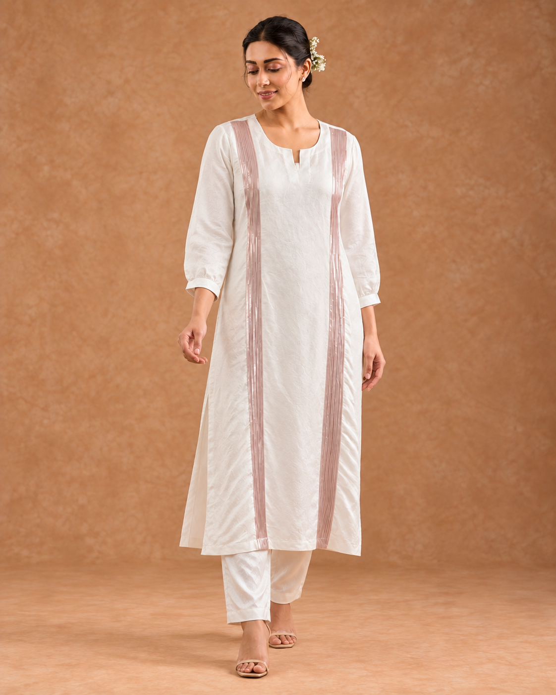 Aurelle by House of Somarra — Walking view showing the white straight trousers and loose tunic.