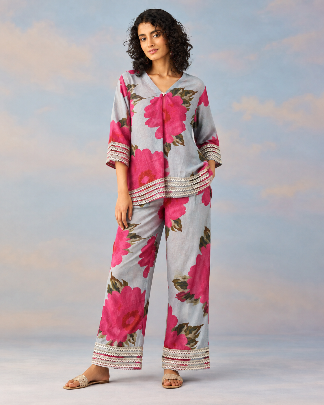 Gulaira by House of Somarra — Front view of the grey outfit with bold pink flowers and striped borders.