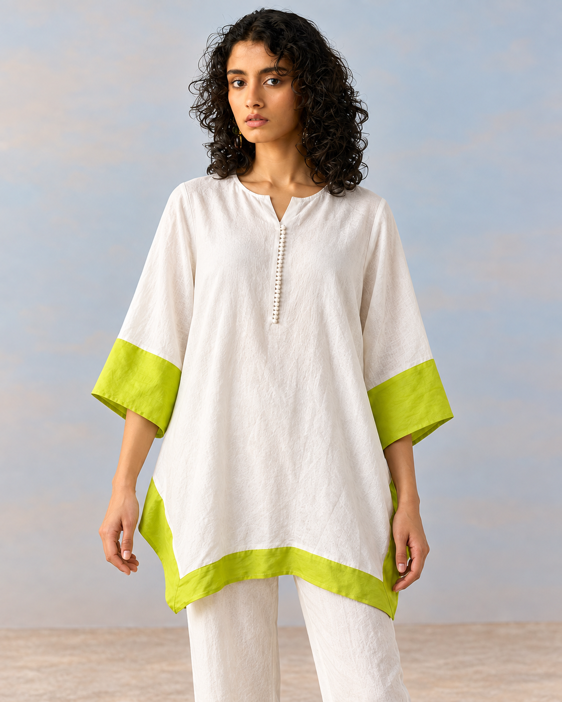 Elara by House of Somarra — Front view of the white tunic and trousers with neon lime cuffs and hem.