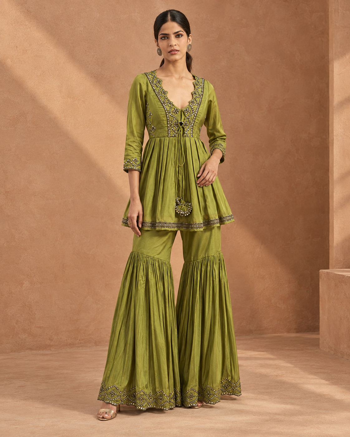 Madhavi by House of Somarra — Front view of the green gathered kurta and flared garara trousers.