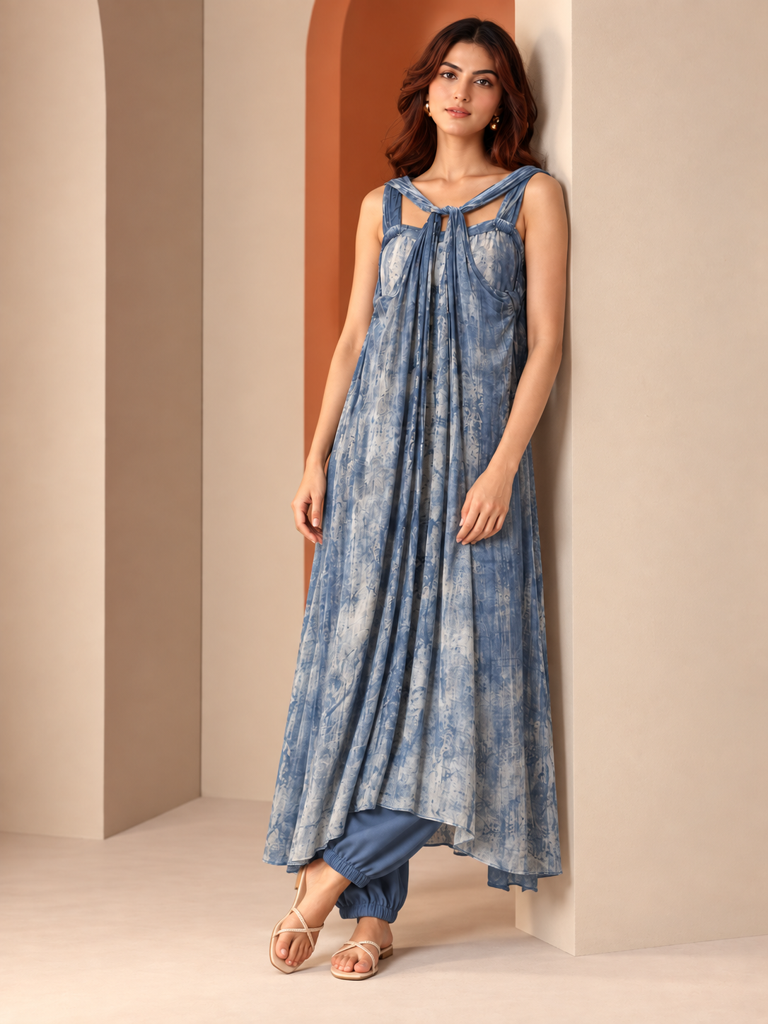 Tisya by House of Somarra — Three-quarter view showing the draped blue hem and asymmetric layers.