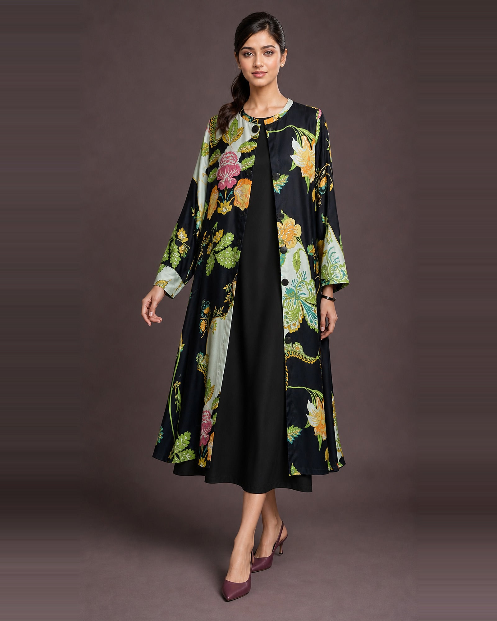 Front-side view of the Vanika black botanical-print front-open midi dress, with its button front and black coverage inner visible