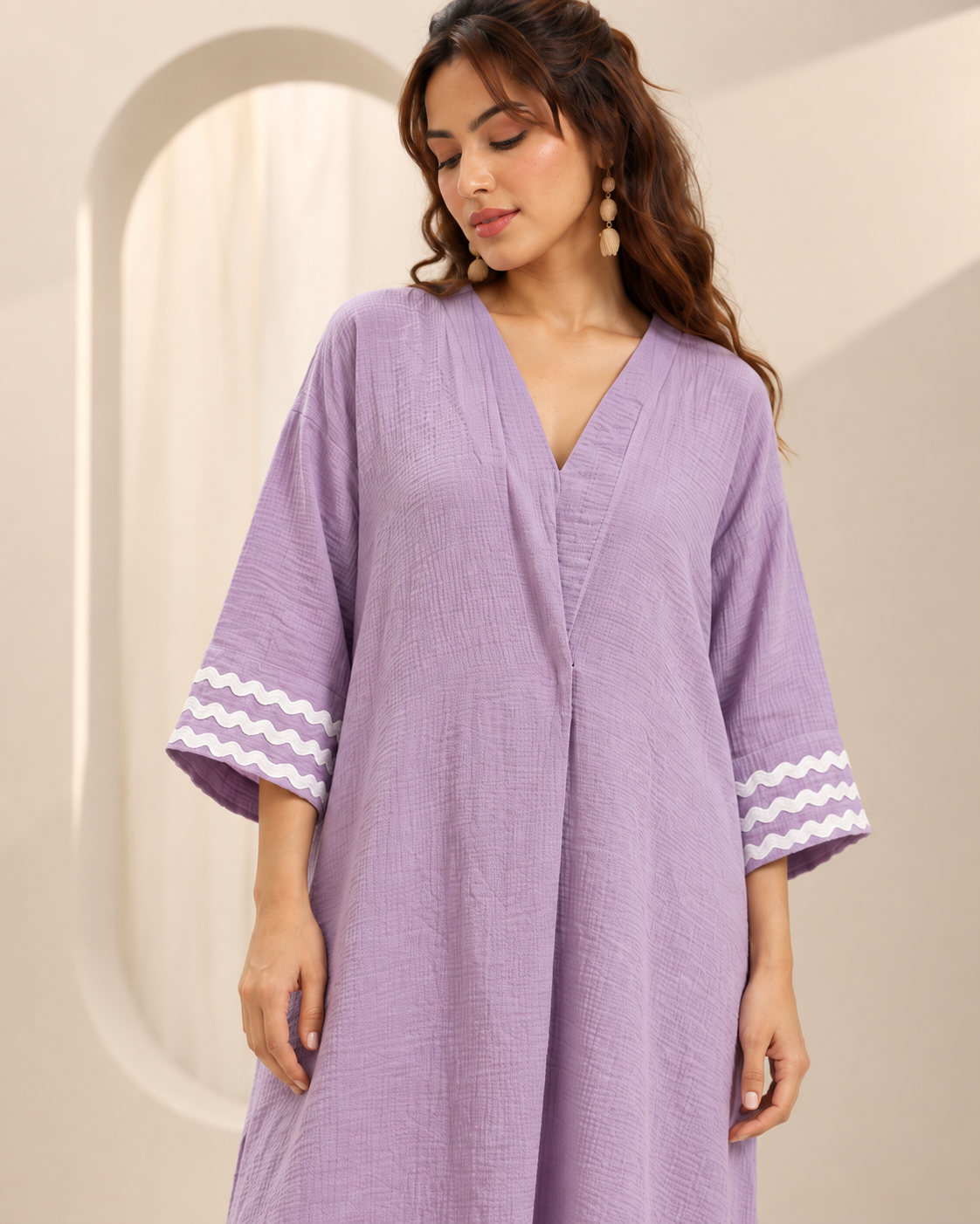 Ameera by House of Somarra — Portrait view of the lilac tunic and white threadwork sleeve bands.