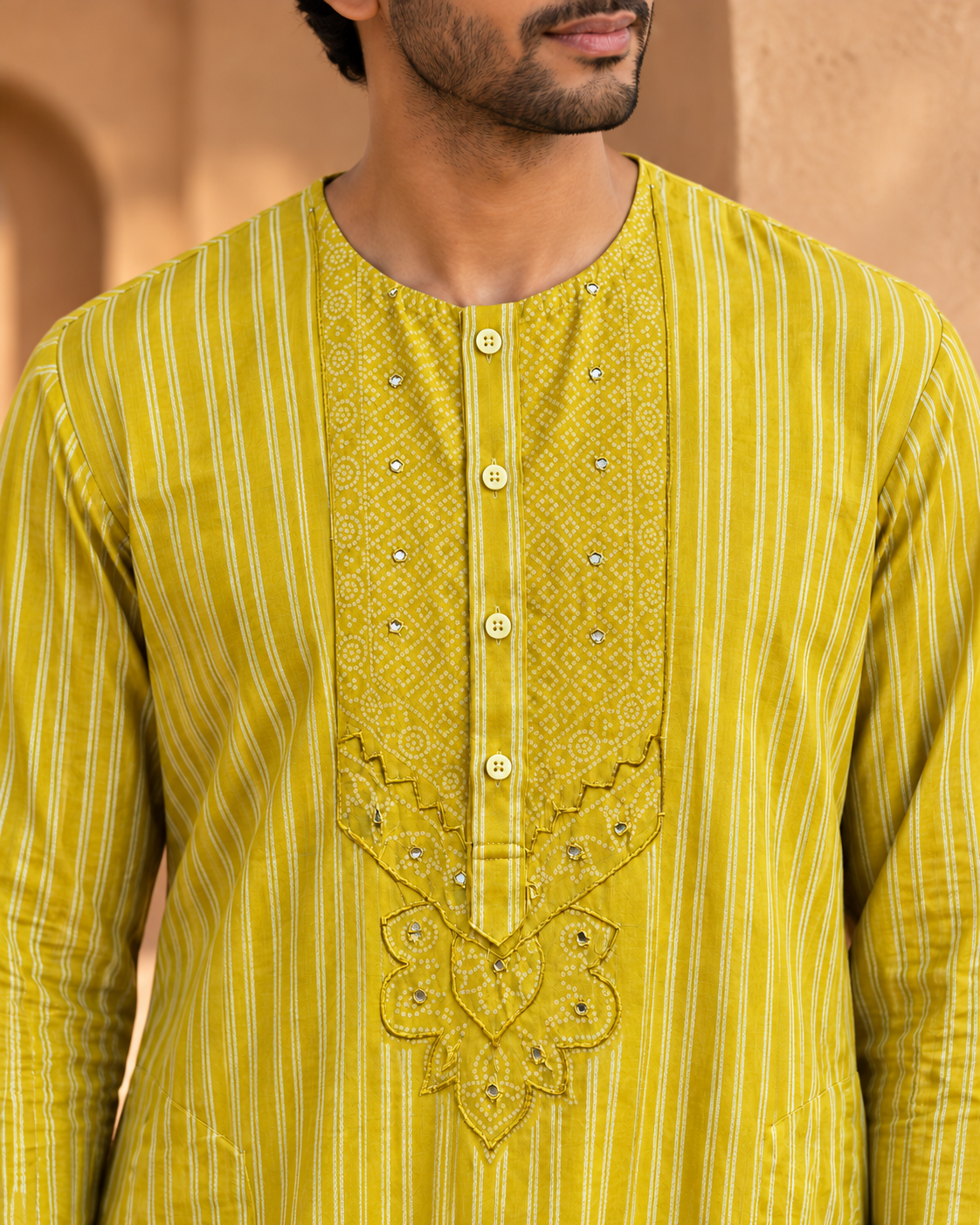 Zarva mustard-yellow kurta — close-up of the dotted yoke, cream stripes and mirror accents.