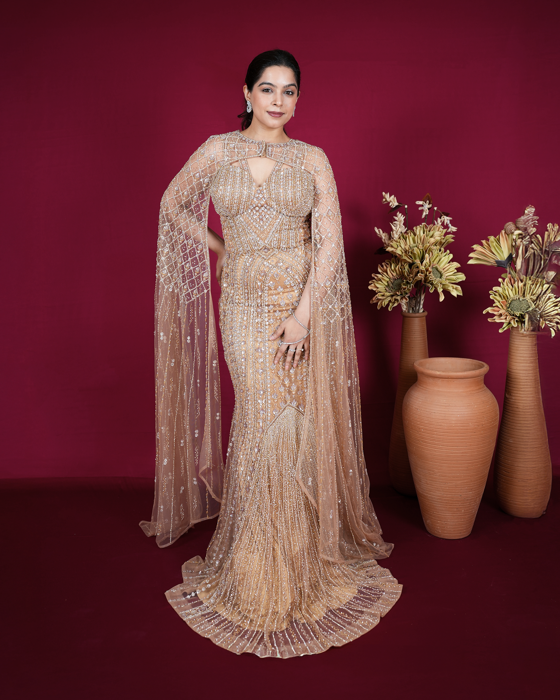 Aurelia by House of Somarra — Full-length front view of the embellished gold-toned gown and sheer cape.