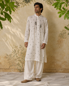 Abeer by House of Somarra — Full-length view of the ivory sprig-embellished kurta and ivory trousers.
