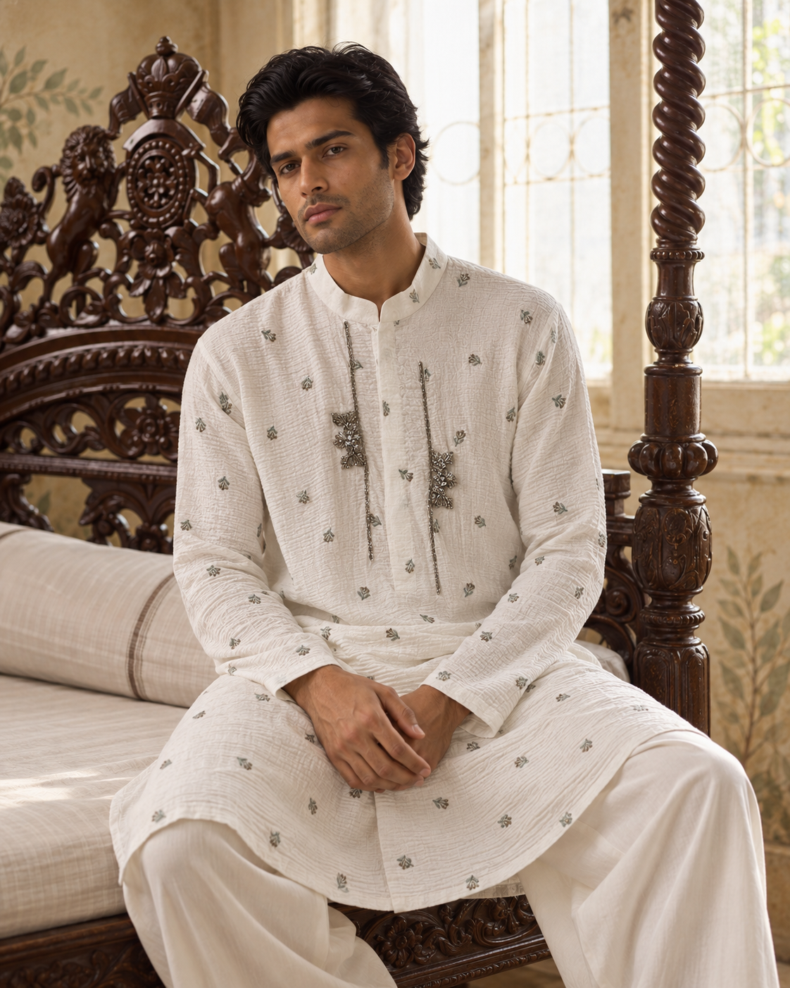 Abeer by House of Somarra — Seated view showing the ivory kurta's small motifs and plain trousers.