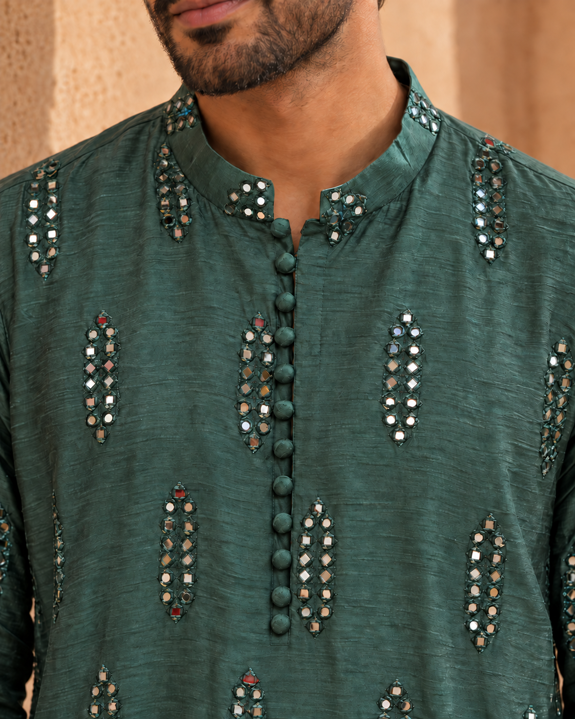 Aks by House of Somarra — Close-up of the band collar, covered buttons and mirror clusters.