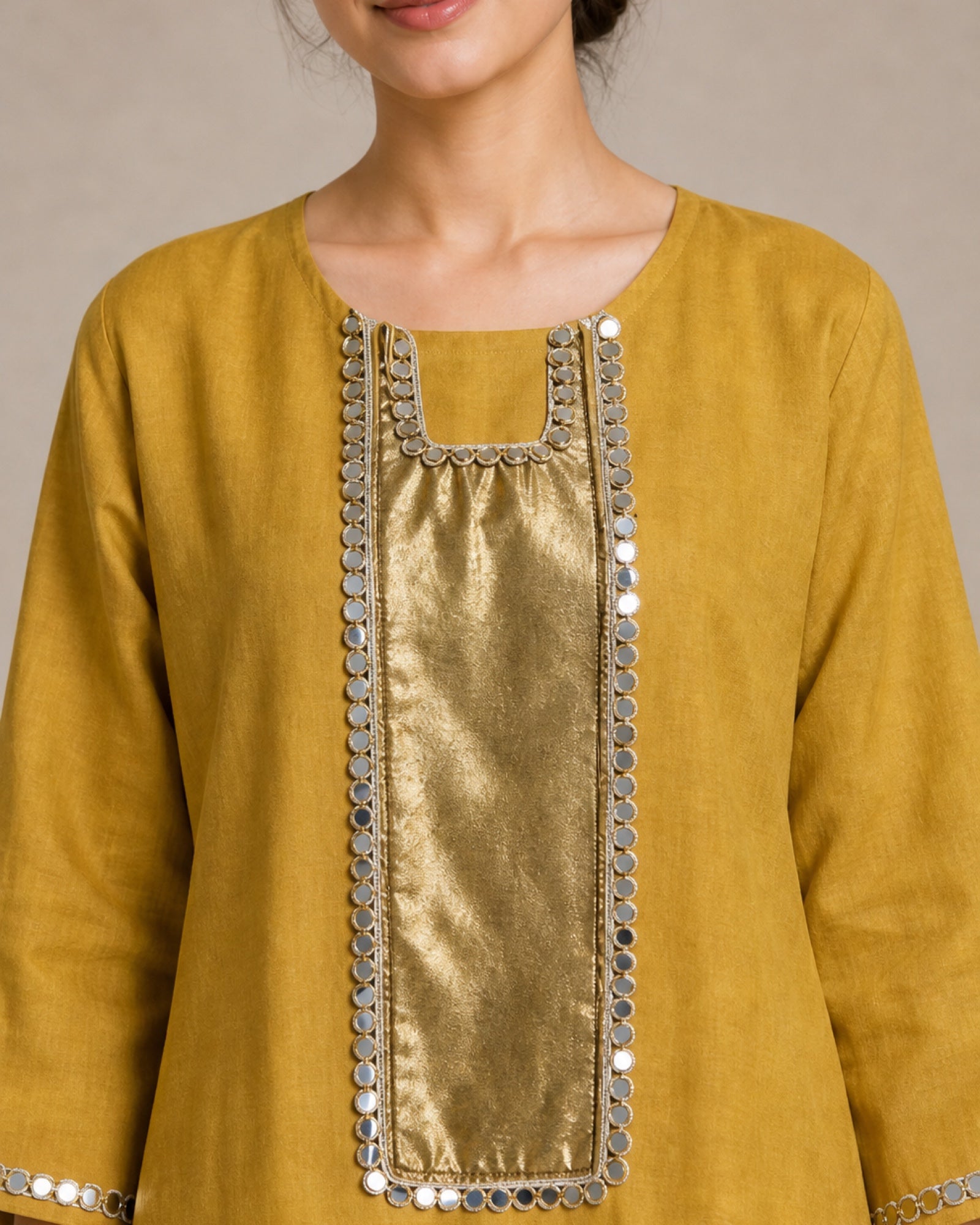 Close view of the Aabha front yoke in antique shimmer, framed with mirror work and mirror lace.