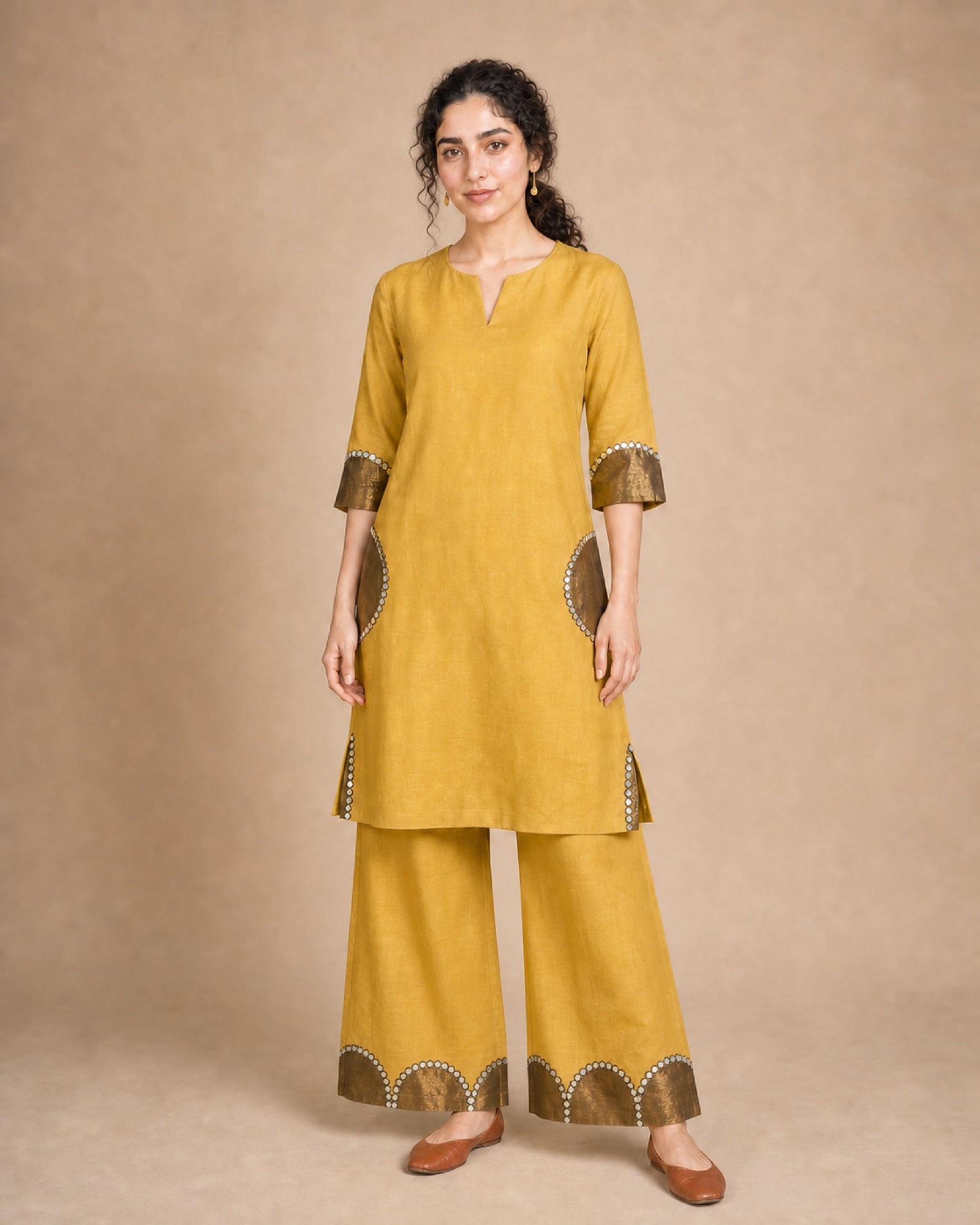 Front view of the Arpita golden-mustard pure-linen shirt-and-palazzo co-ord suit with antique-shimmer and mirror-lace semicircle patch work