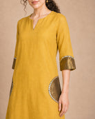 Close-up of the Arpita shirt pocket and sleeve semicircle patch work in antique shimmer with mirror-lace detailing