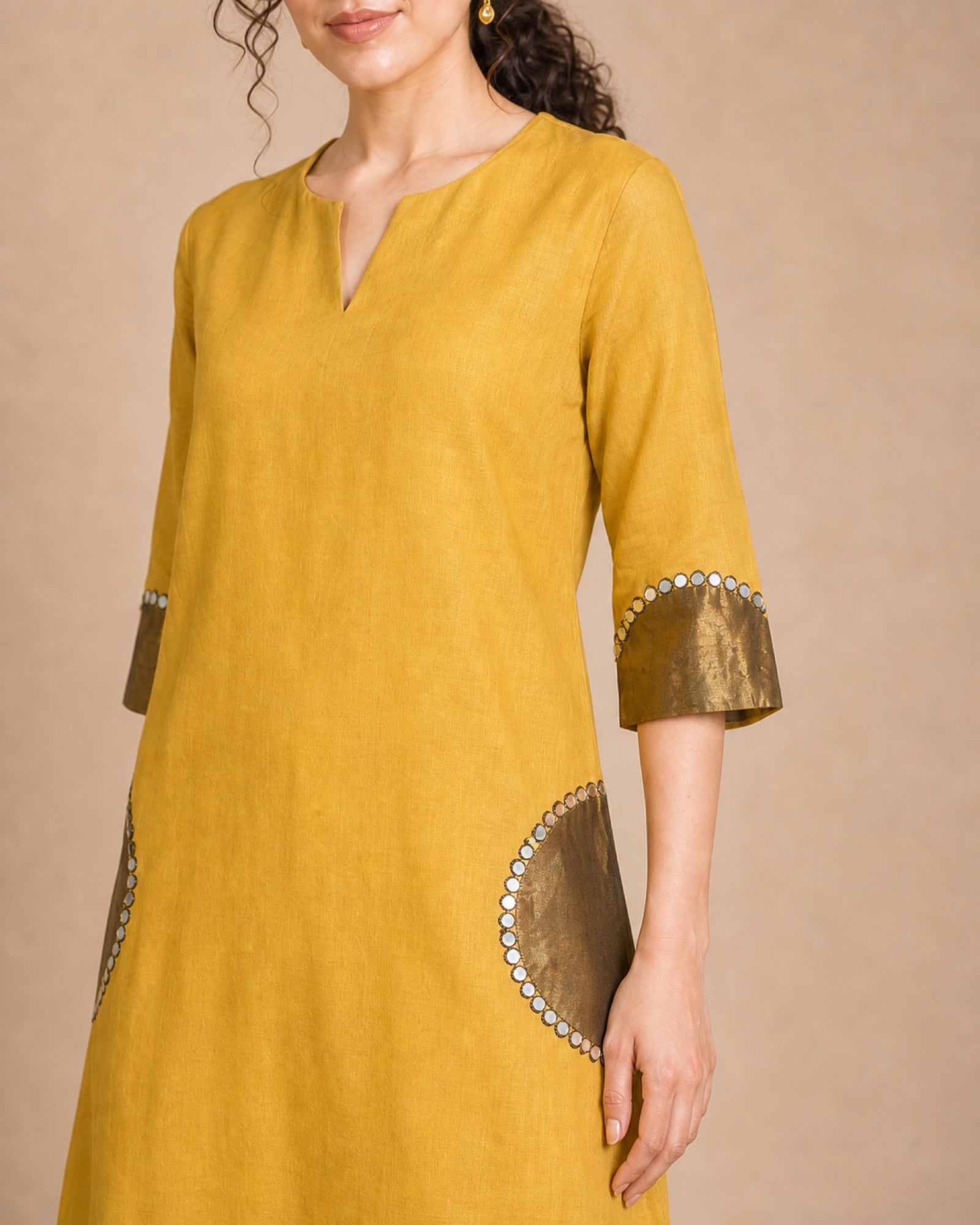 Close-up of the Arpita shirt pocket and sleeve semicircle patch work in antique shimmer with mirror-lace detailing