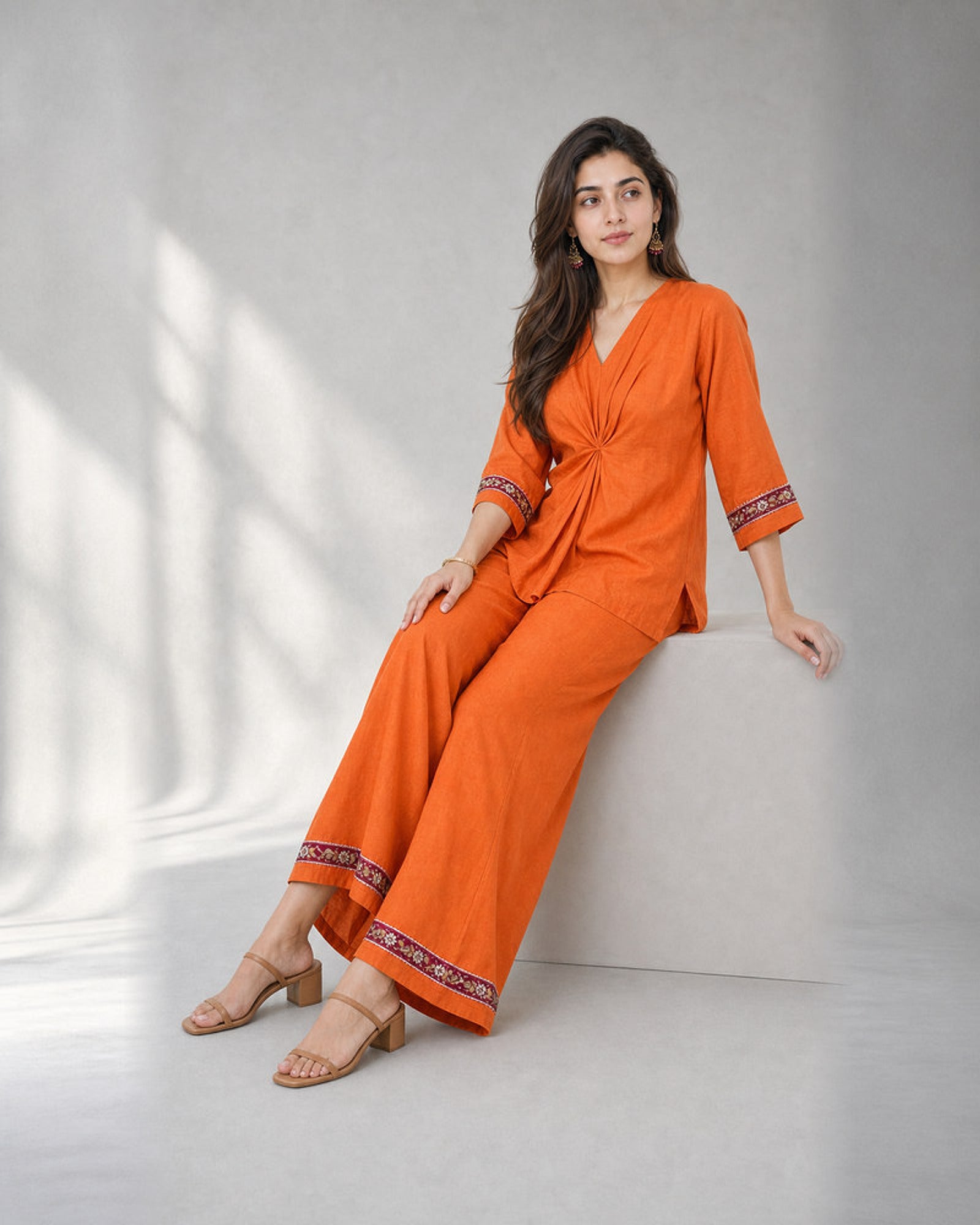 Arunika: Vibrant Orange Embroidered Co-ord Set – seated three-quarter
