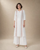 Aurelle white linen co-ord set with rose-gold-colour structured front trim and matching broad linen palazzos, front view