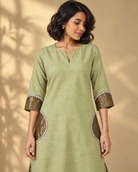 Arpita by House of Somarra — Portrait view of the neckline and broad sleeve cuffs.