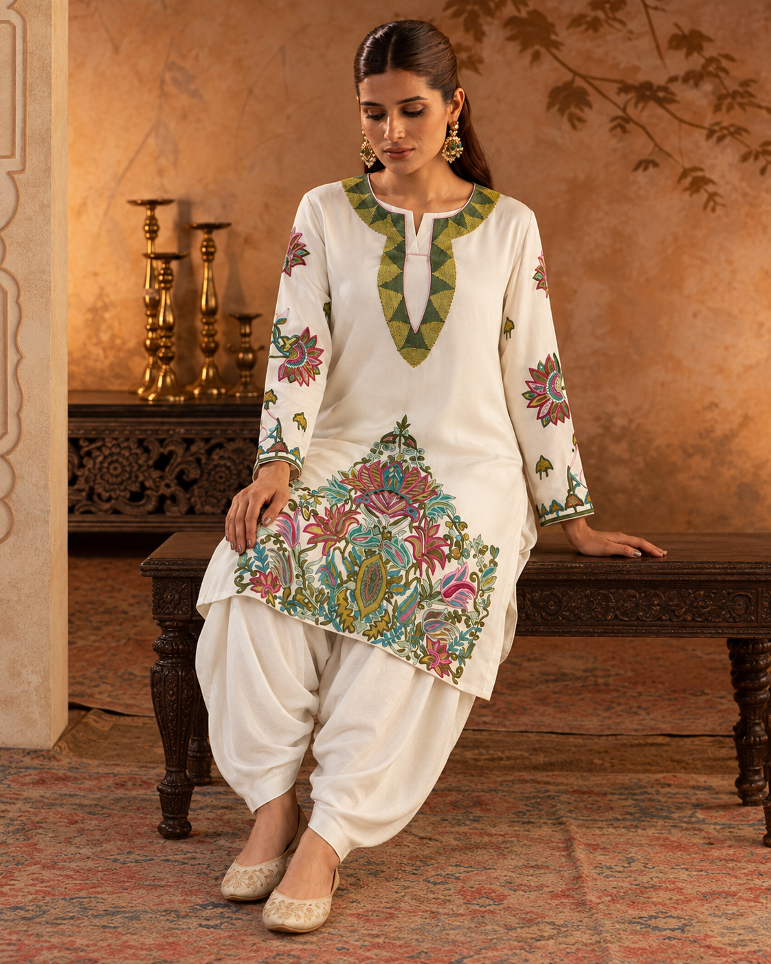 Vasantika by House of Somarra — Seated view showing the ivory draped trousers and embroidered hem.