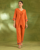 Arunika by House of Somarra — Walking view of the orange co-ord silhouette.