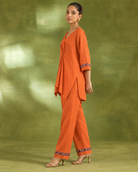 Arunika by House of Somarra — Side view showing the orange top's asymmetric drape.