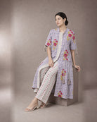 Eshani: Peacock Purple Check & Floral Dori Co-ord Set – seated three-quarter