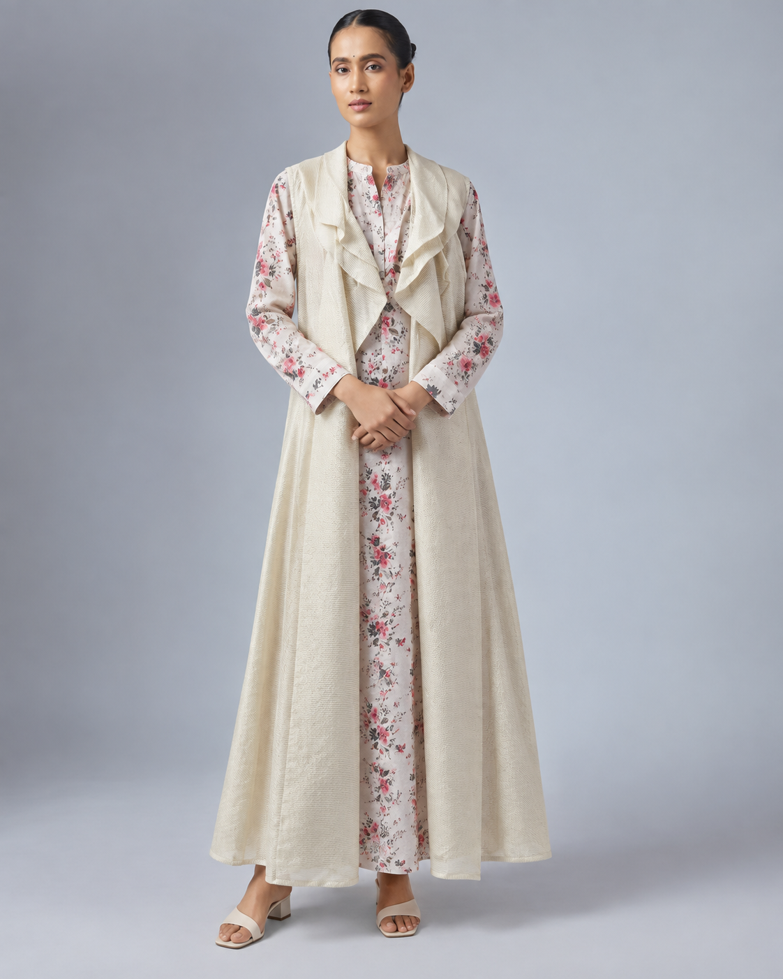 Varnika by House of Somarra — Front view of the layered floral kurta and pale shrug.