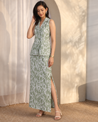 Olivara by House of Somarra — Three-quarter view showing the collared top and skirt's side slit.