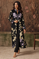 Hanami by House of Somarra — Walking view showing the embroidered botanical panels and black trousers.