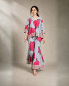 Gulaira bold pink floral lace garara co-ord set – controlled front walking view