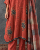 Agnira by House of Somarra — Close-up of the embroidered orange fabric and checked dupatta.