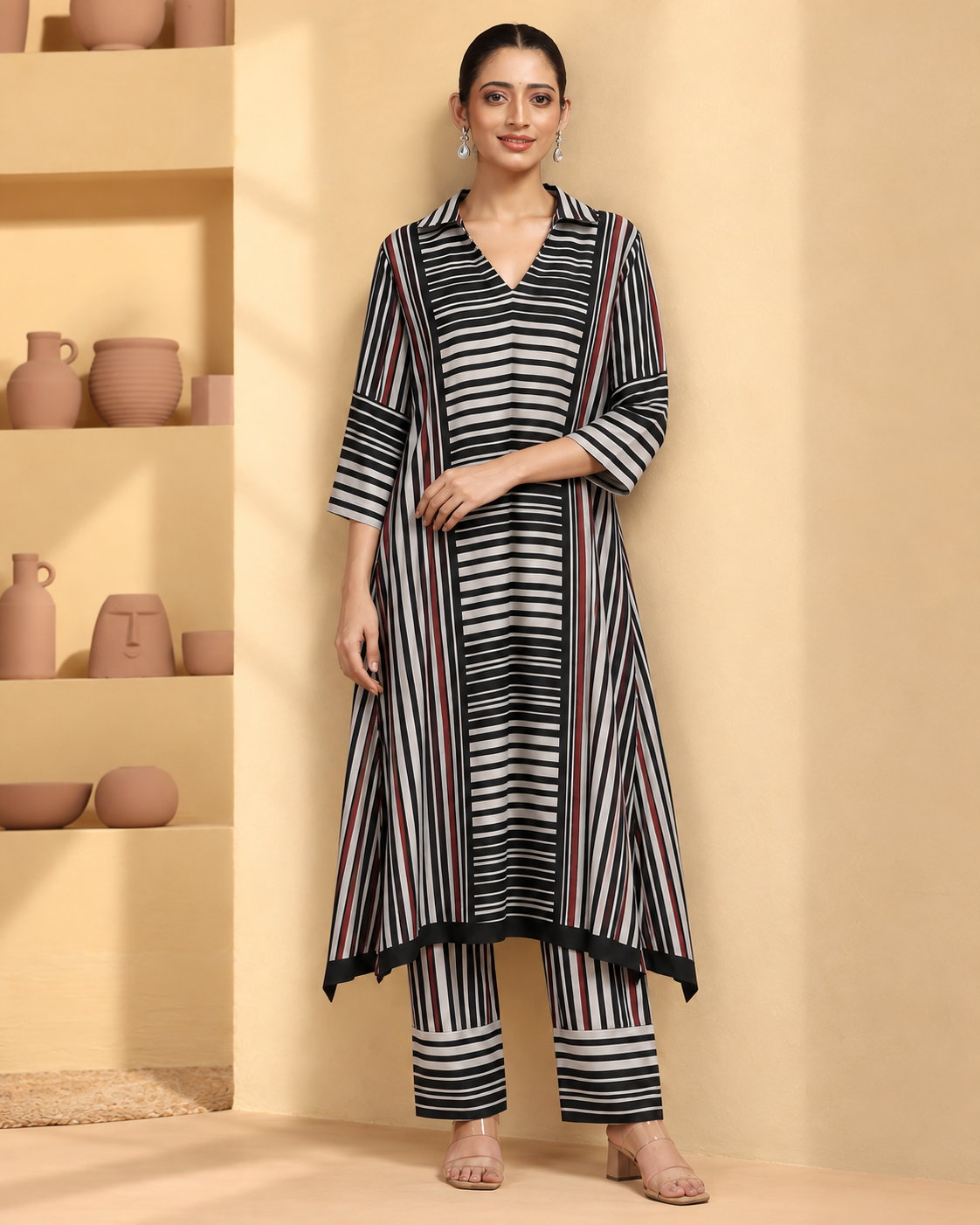 Tirya by House of Somarra — Front view of the striped ensemble with hands at the waist.