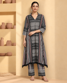 Tirya by House of Somarra — Front view of the striped ensemble with hands at the waist.