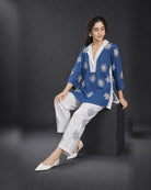 Neelakshi: Blue-and-White Floral Cutwork Co-ord Set – seated three-quarter