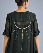 Pearl detailing on the Shyama dark green draped top, close-up