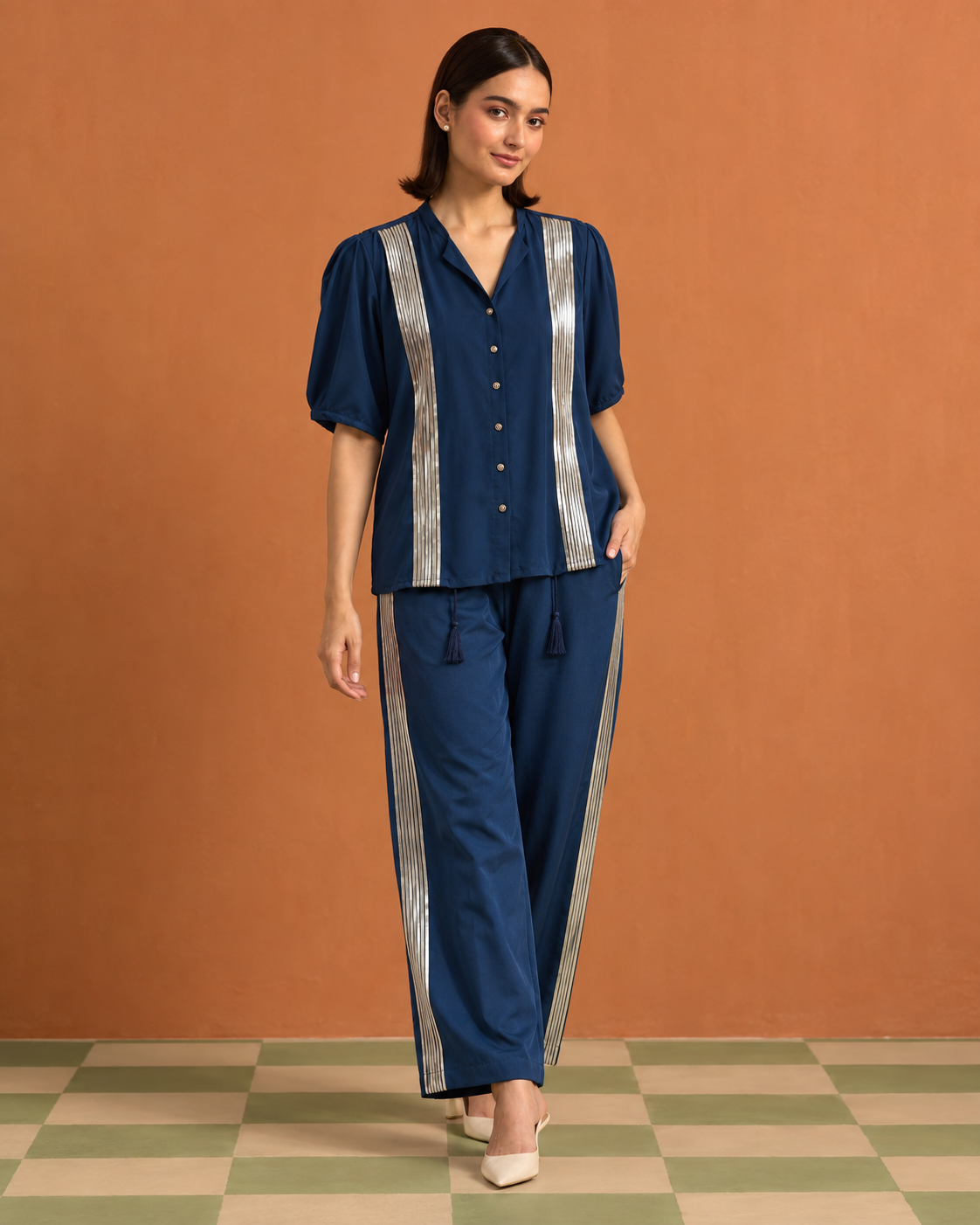 Tarini by House of Somarra — Front view of the blue shirt and trousers with rose-gold vertical bands.