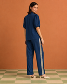 Tarini by House of Somarra — Back view showing the blue shirt and striped trouser sides.