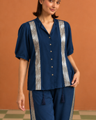 Tarini by House of Somarra — Close-up of the shirt collar, buttons and metallic front bands.