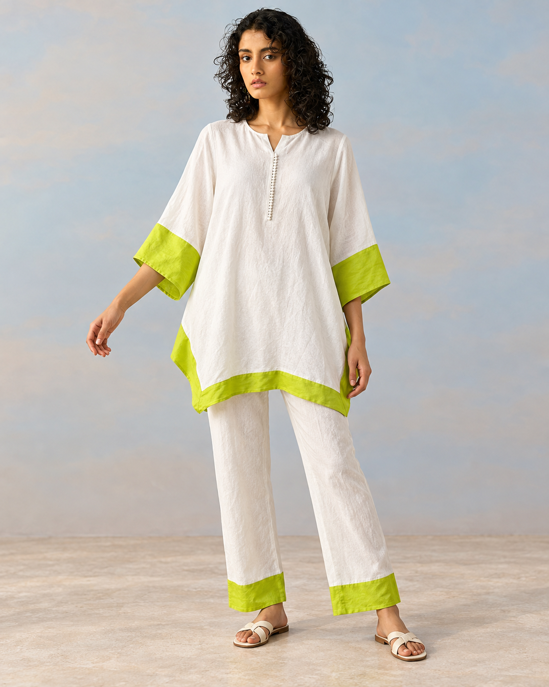 Elara by House of Somarra — Full-length view of the loose white outfit with lime trim.