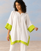 Elara by House of Somarra — Portrait view showing the white tunic and bright lime sleeve bands.