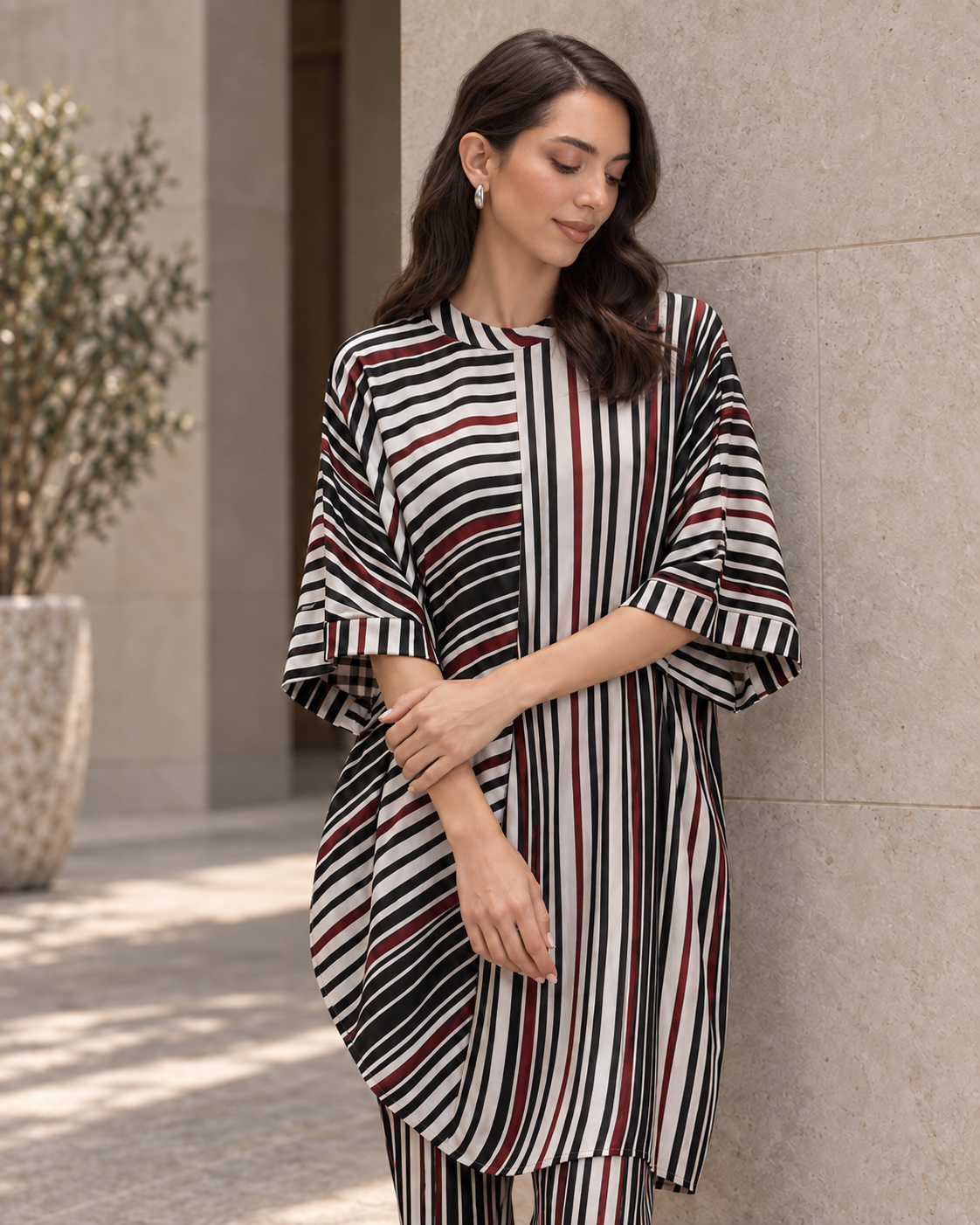Vayra by House of Somarra — Portrait view of the black, white and red striped cowl tunic.