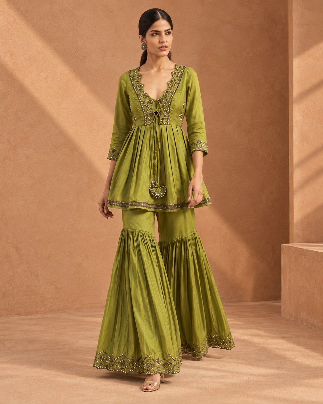 Madhavi by House of Somarra — Walking view showing the gathered peplum and flared trousers.