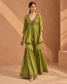 Madhavi by House of Somarra — Walking view showing the gathered peplum and flared trousers.